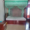 teal mosquito net for bed in a bedroom