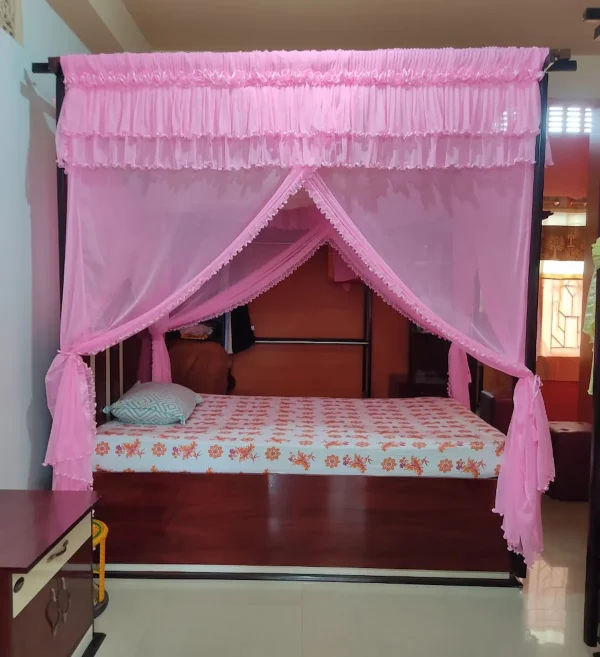 light pink mosquito net for bed in a bedroom