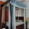Gray and white curtain mosquito net in a bedroom