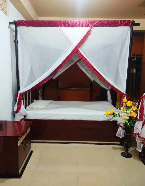 maroon striped mosquito net for bed in a bedroom