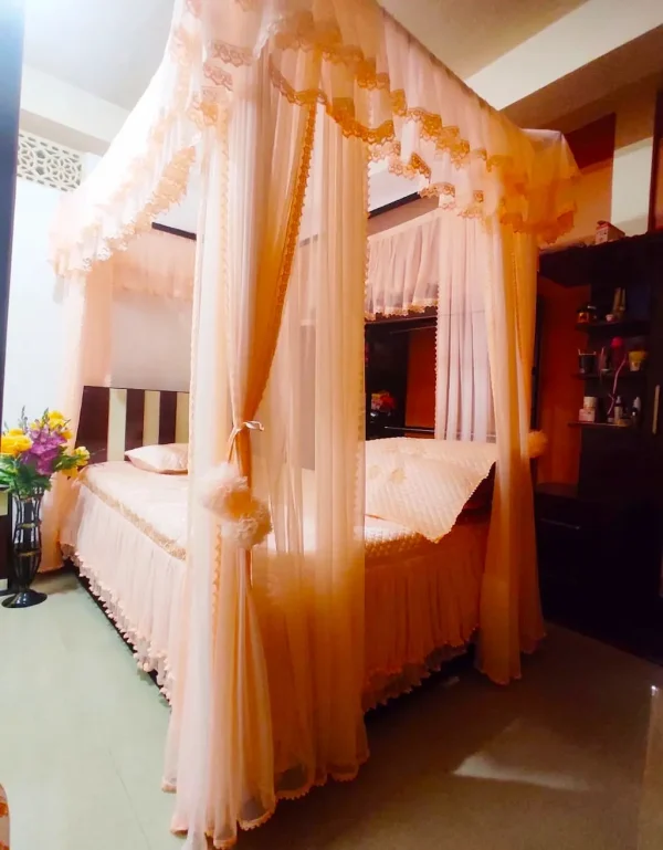 peach designer curtain style mosquito net in a room