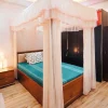 peach color curtain style mosquito net in a bedrom
