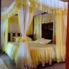 gold yellow and white designer curtain mosquito net in a bedroom