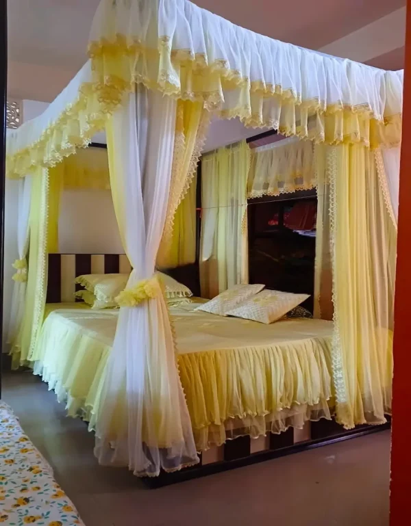 gold yellow and white designer curtain mosquito net in a bedroom