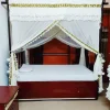 laced white mosquito net for bed in a bedroom