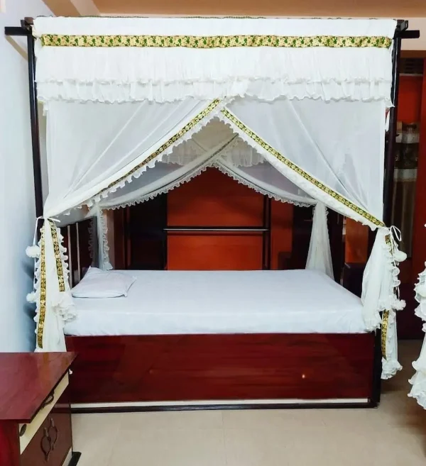 laced white mosquito net for bed in a bedroom